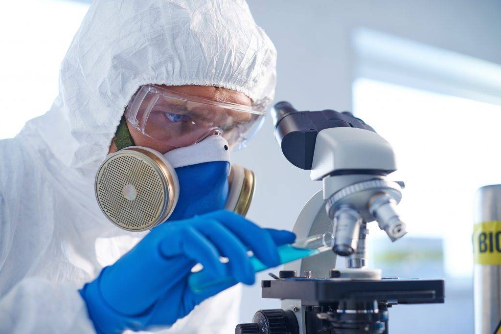 graphicstock-male-chemist-in-protective-clothing-studying-new-fluid-in-lab_HmECf_UGEW-scaled
